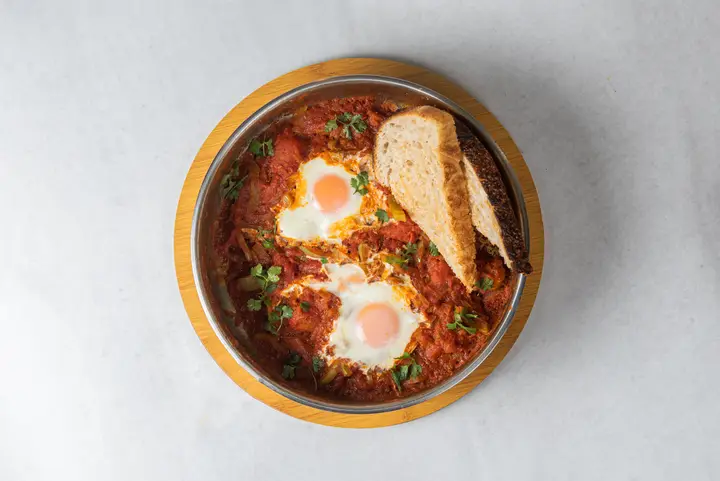 Shakshuka with eggs and bread